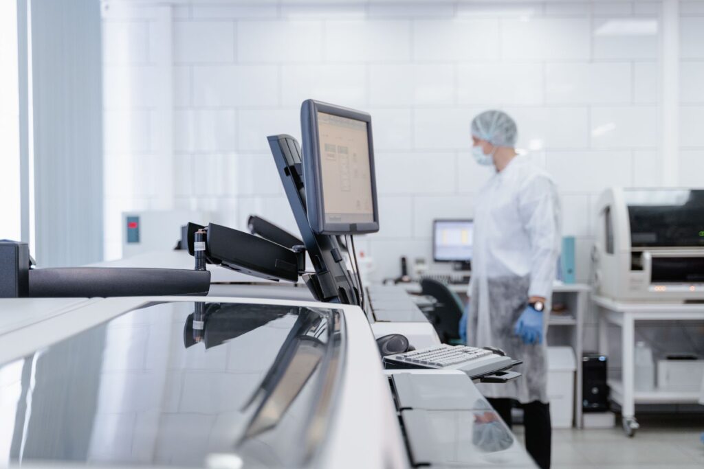 Laboratory technician working with advanced research equipment representing AI and quantum convergence.