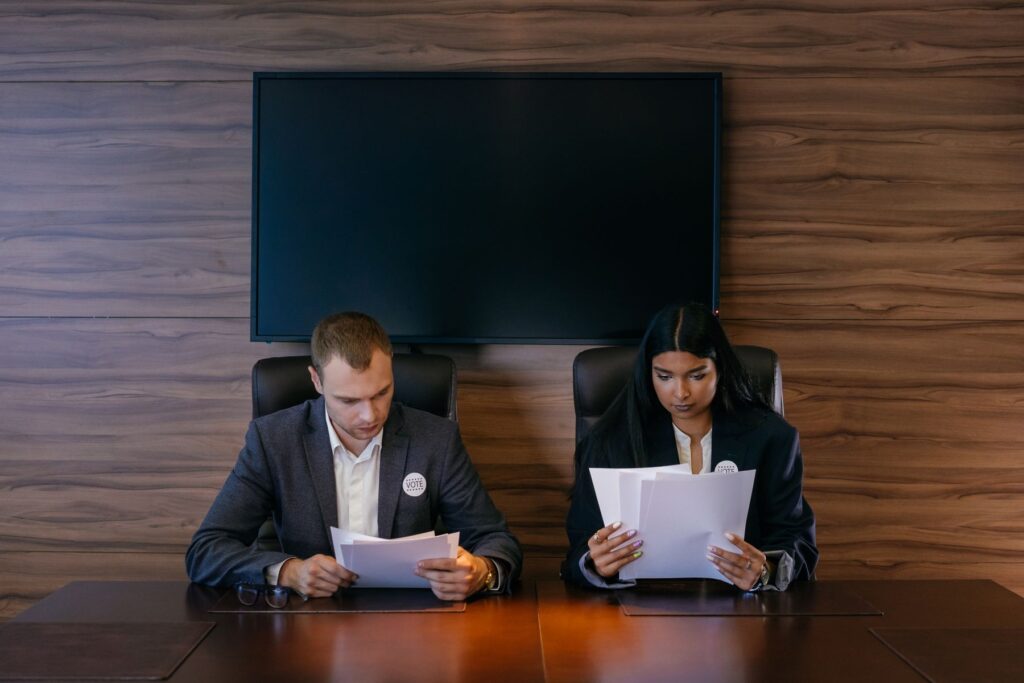 Professionals reviewing evidence and documentation in a modern boardroom, representing responsible AI governance and assurance.