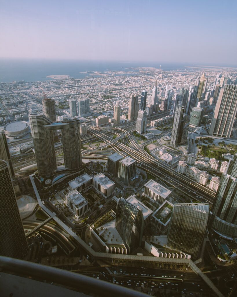 High-angle aerial view of Dubai's modern urban landscape and skyline representing economic scale, infrastructure, and institutional development.